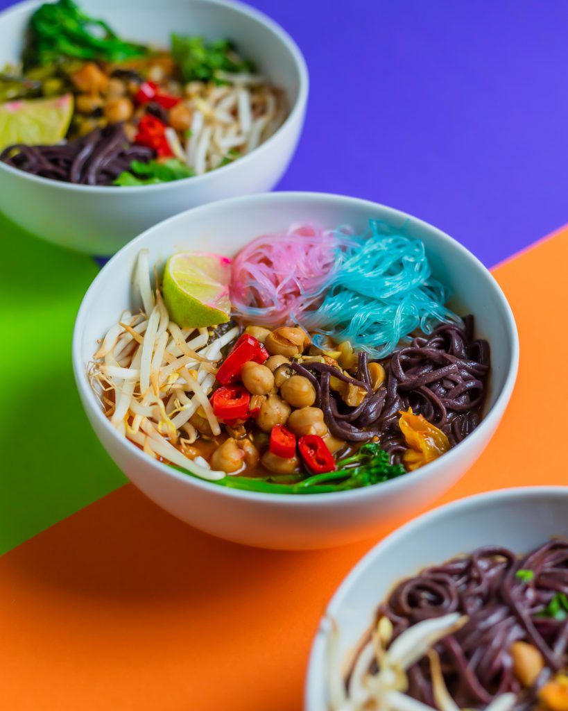 Bowls of soup on colourful backdrop