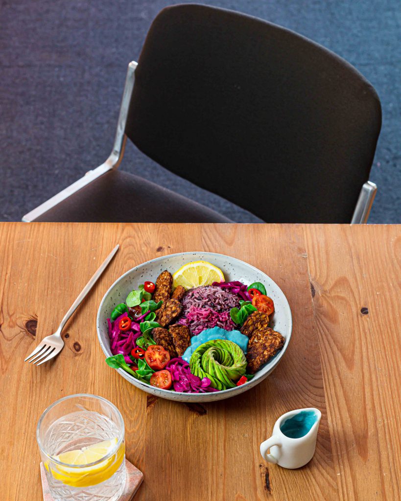 Table set with tempeh salad bowl