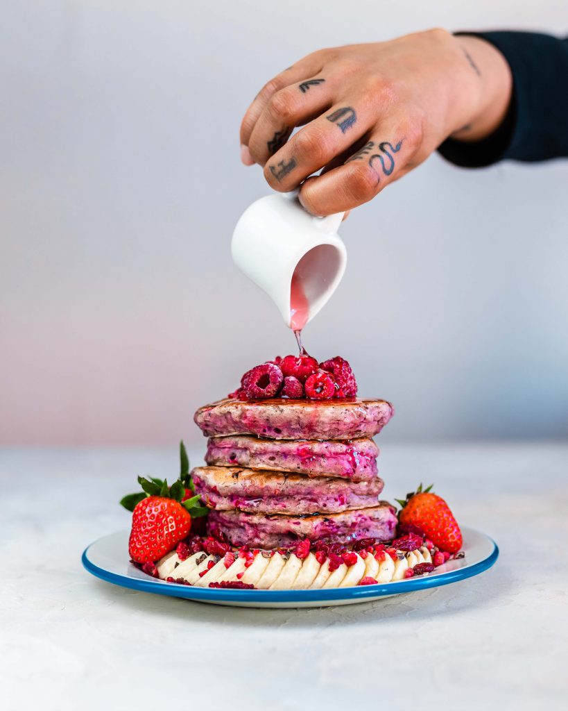 Pouring rose elixir on top of the pancakes