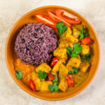 A bowl with celeriac curry and purple rice