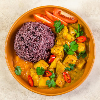 A bowl with celeriac curry and purple rice